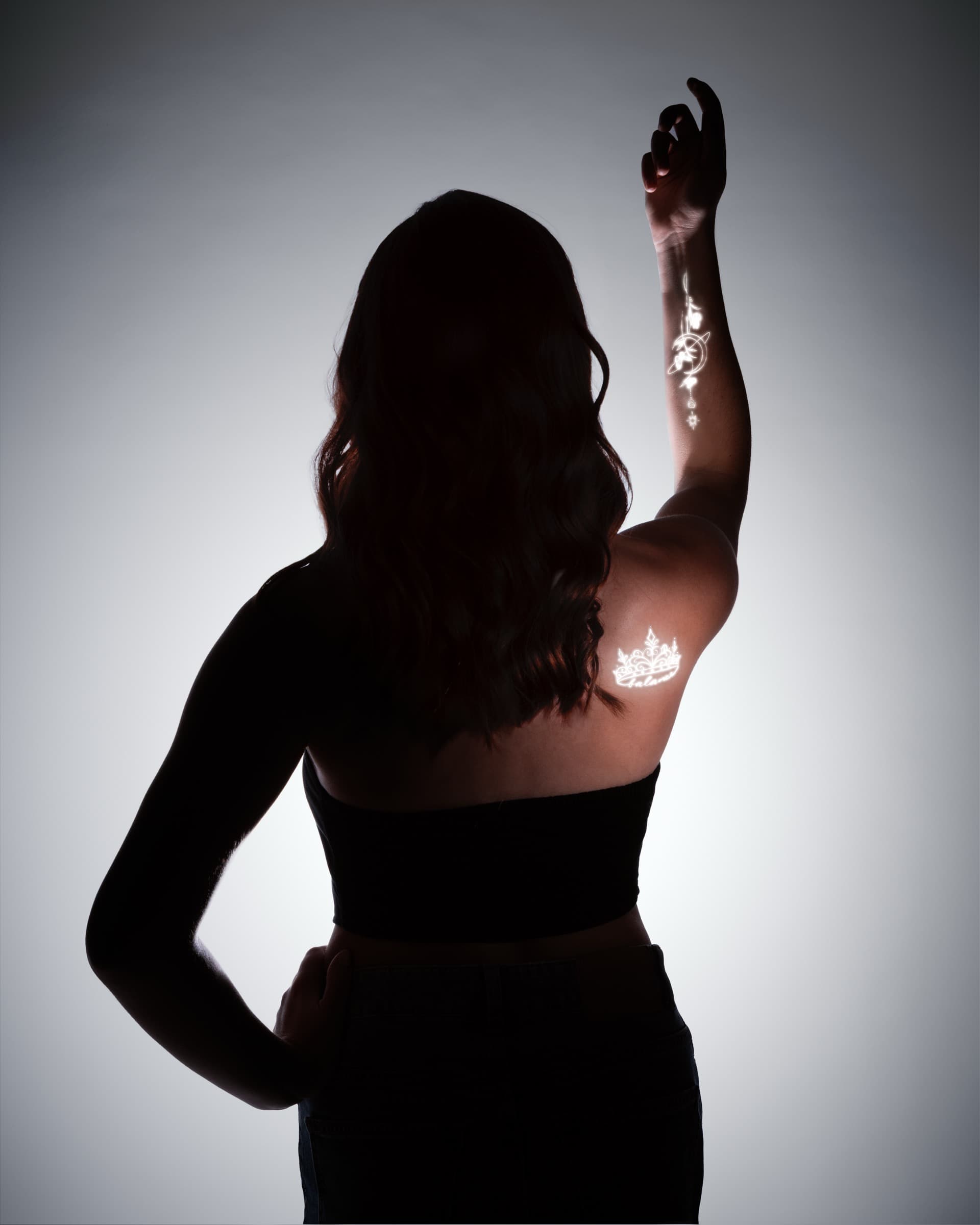 Silhouette portrait with projected light tattoo