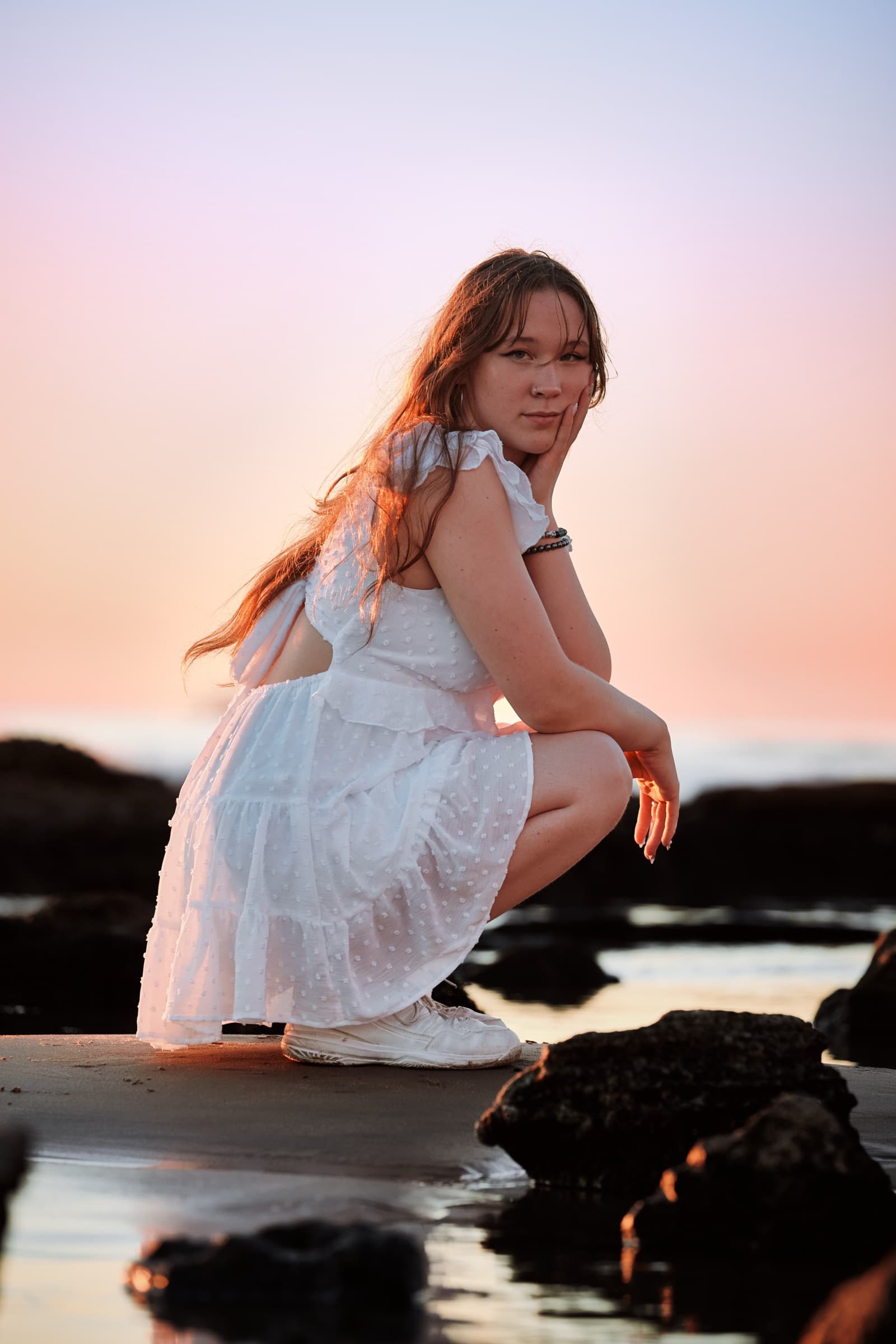 Beach portrait at pastel-pink sunset