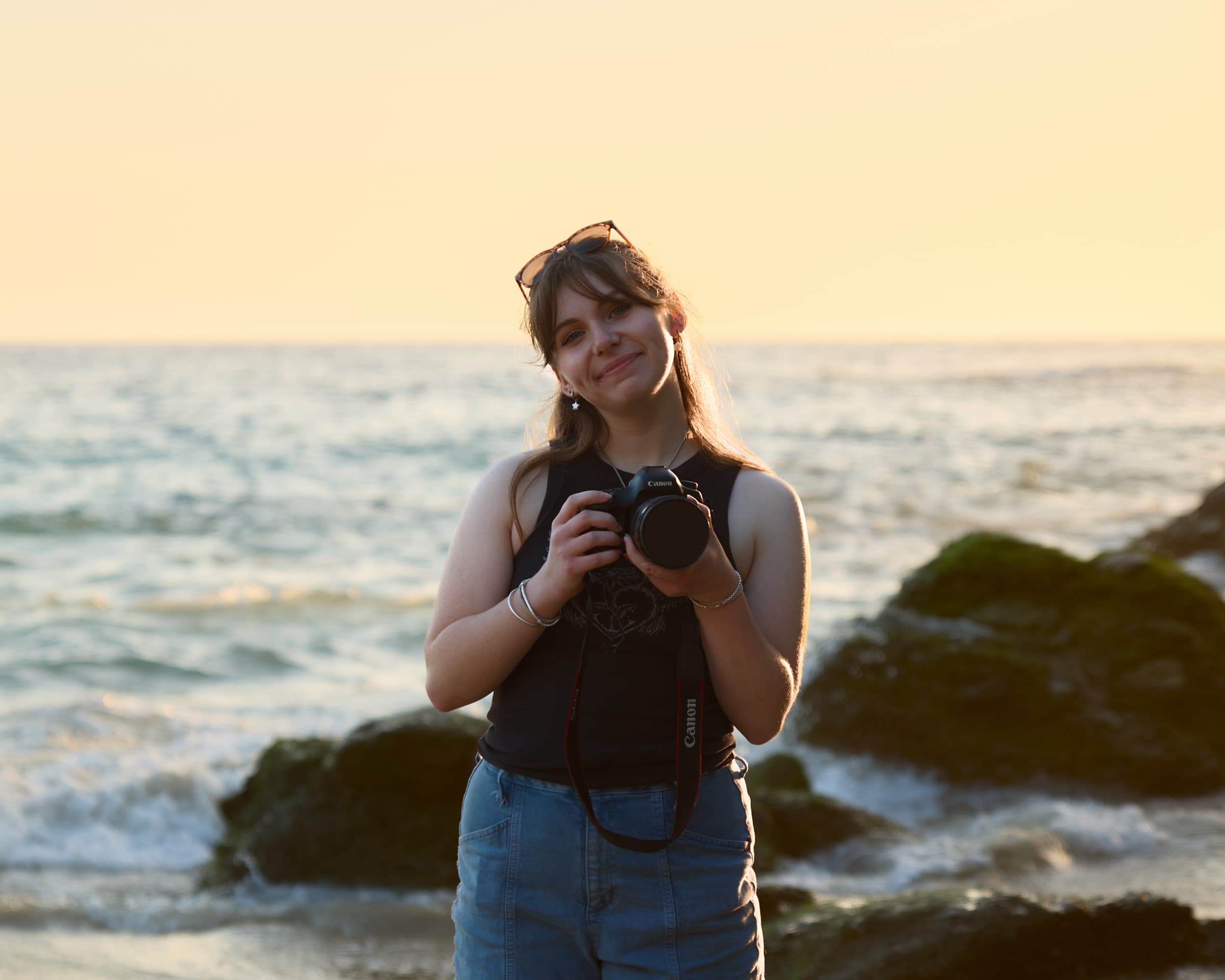 Golden-hour portrait on the rocks with film camera